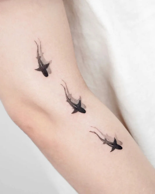 Small Minimalist Sharks on Women Arm Tattoo by @oble_tattoo