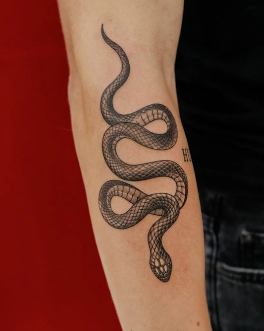 Small Minimalist Snake on Men Arm Tattoo by @dragoncityink.danang
