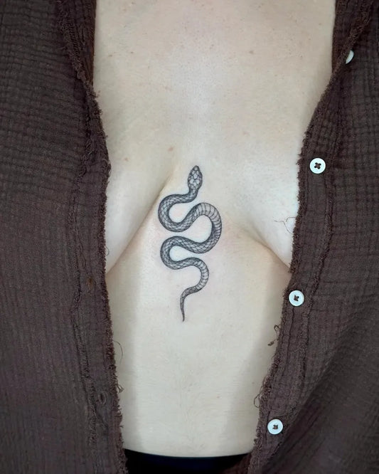 Small Minimalist Snake on Women Sternum Tattoo by @ipektattoo