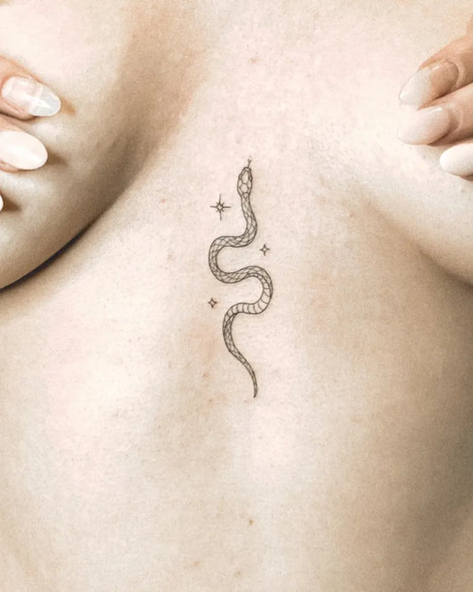 Small Minimalist Snake with Stars on Women Sternum Tattoo by @mayflowerink