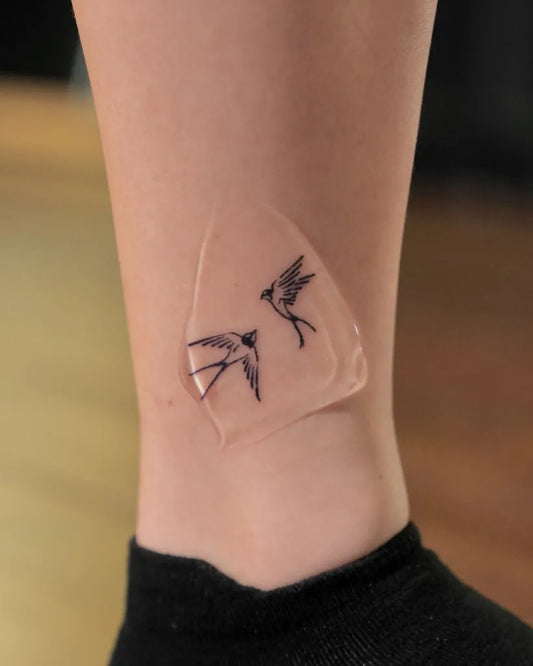 Small Minimalist Sparrow Tattoo on Women Ankle by @niunai.tattoo