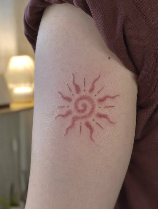 Small Minimalist Spiral Sun on Women Upper Arm Tattoo by @namaste_poke