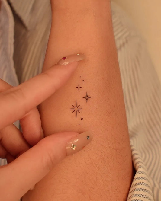 Small Minimalist Star Cluster on Women Forearm Tattoo by @tinytattooinc