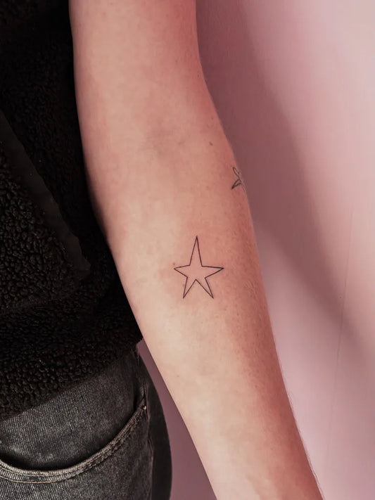 Small Minimalist Star Tattoo on Women Arm by @amelierosetattoos