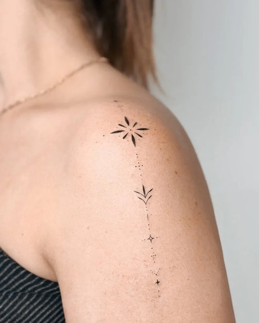 Small Minimalist Star and leaf on women shoulder Tattoo by @cha.tattoo