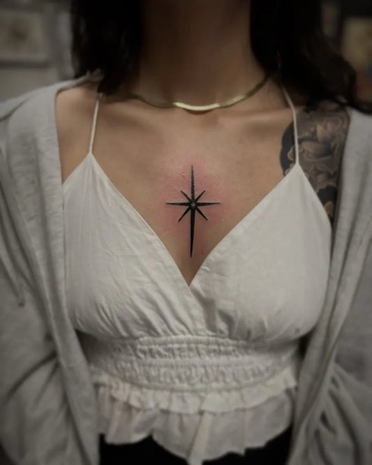 Small Minimalist Star on Women Chest Tattoo by @ryangraytattoos