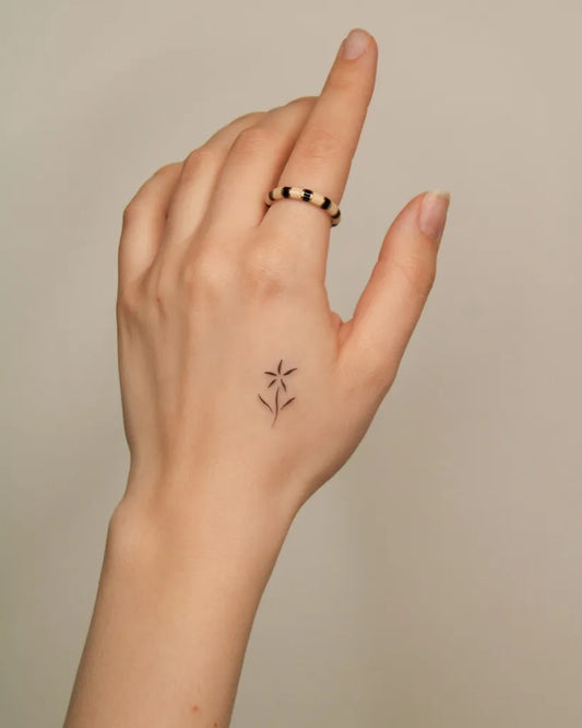 Small Minimalist Starflower on Women Hand Tattoo by @tinytattooinc