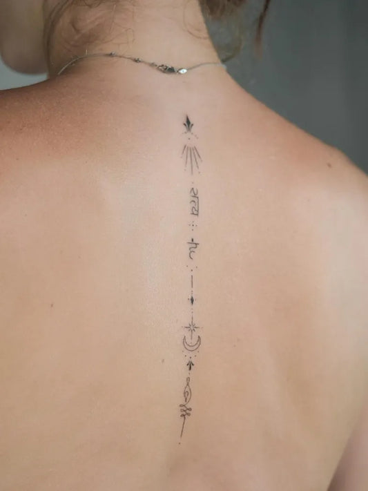 Small Minimalist Sun Arrow Moon on Women Spine Tattoo by @thepeople.tattoo