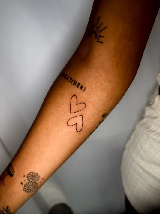 Small Minimalist Sun Feathers Double Hearts Daisy on Women Arm Tattoo by @inkgenics
