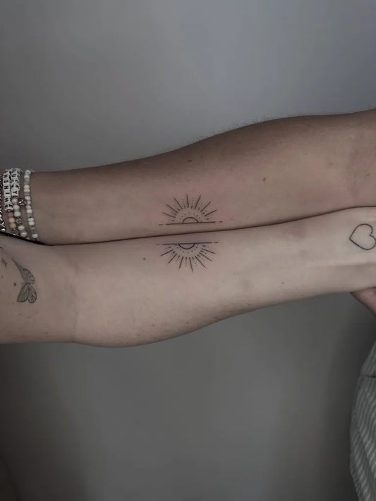 Small Minimalist Sun Heart on Friends Arms Matching Tattoo by @yink_tattoos
