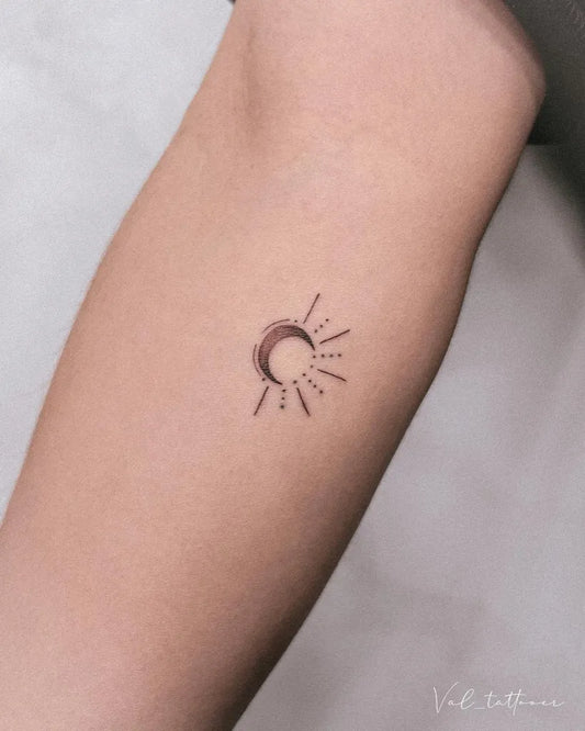 Small Minimalist Sun and Crescent Moon on Women Forearm Tattoo by @val_tattooer