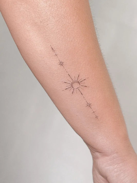Small Minimalist Sun and Stars Tattoo on Women Arm by @maria_eduarda_tattoo_artist