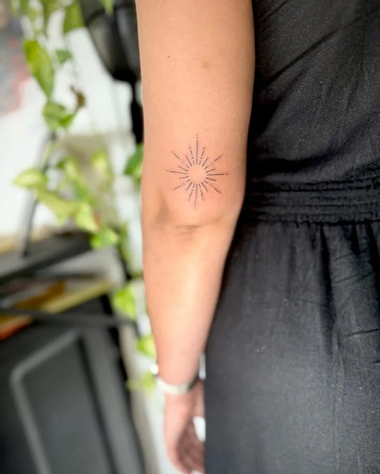 Small Minimalist Sun on Women Arm Tattoo by @bo.m_tattoo