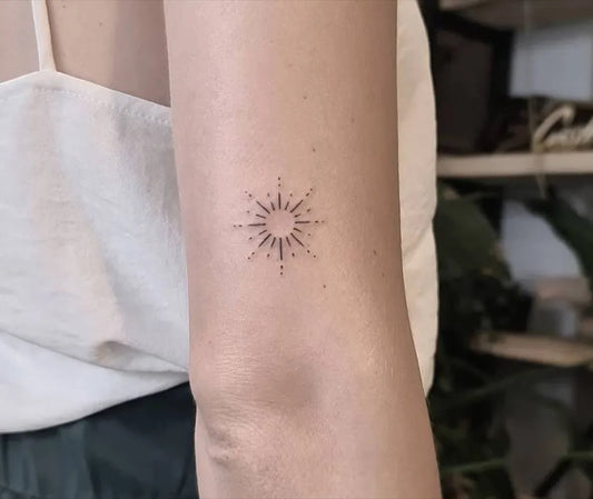 Small Minimalist Sun on Women Arm Tattoo by @inkepedia