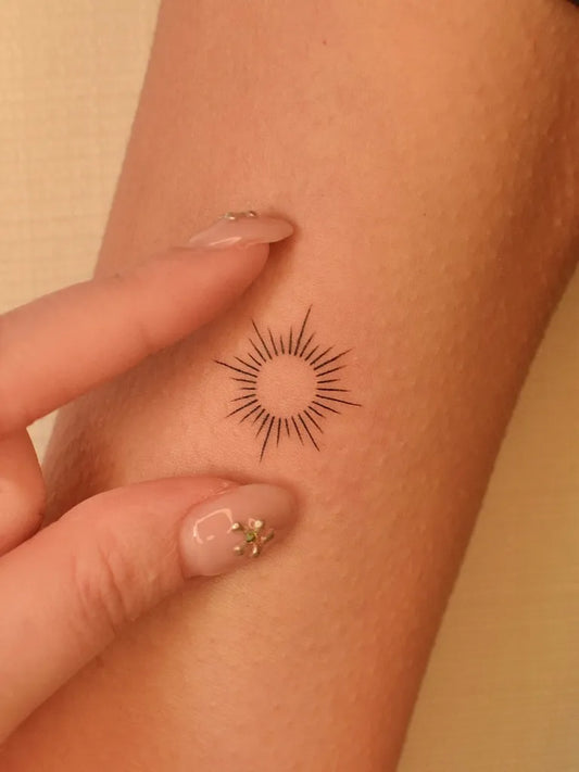 Small Minimalist Sun on Women Arm Tattoo by @tinytattooinc