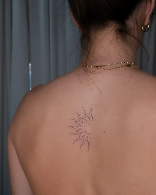 Small Minimalist Sun on Women Back Tattoo by @elenaskinart