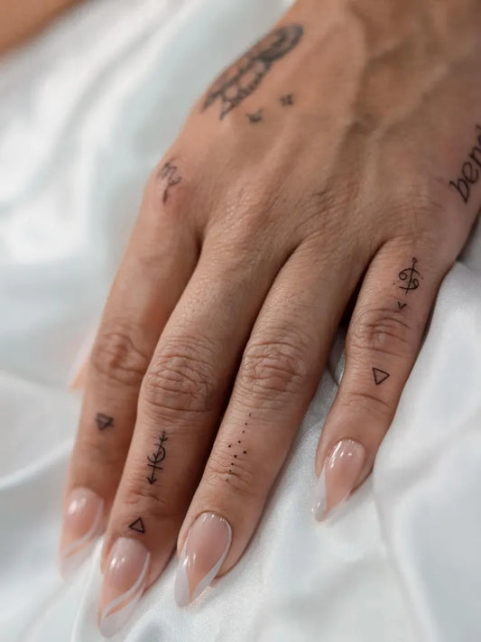 Small Minimalist Symbols on Women Hand Tattoo by @andressa.artist