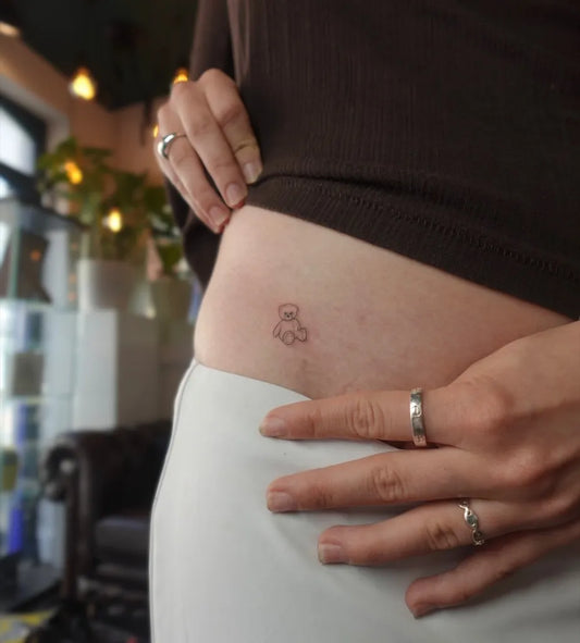 Small Minimalist Teddy Bear on Women Hip Tattoo by @peach.tats
