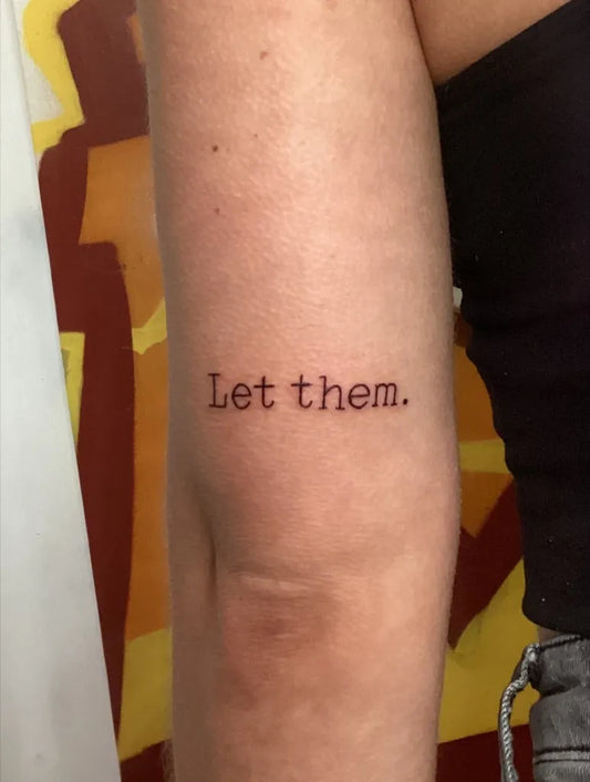 Small Minimalist Text Let Them on Women Arm Tattoo by @zestyzacchtattoos