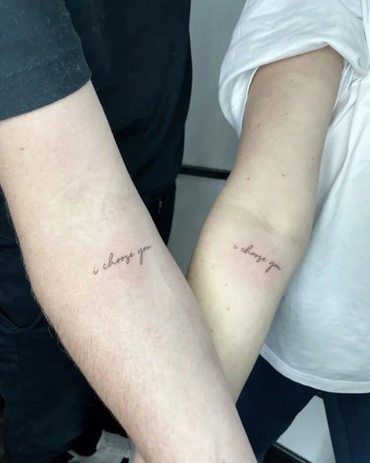 Small Minimalist Text on Couple Arms Matching Tattoo by @kaptaan_tattoo