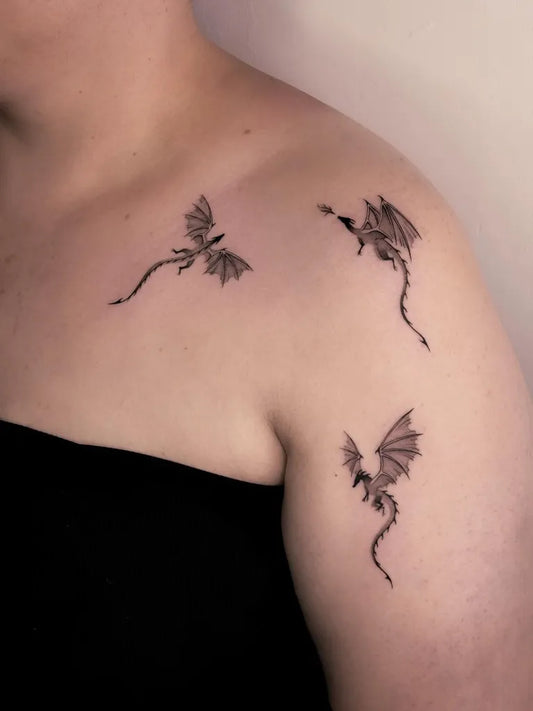 Small Minimalist Three Dragons on Women Shoulder Tattoo by @valeries.tattoo