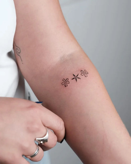 Small Minimalist ThreeDaisies on Women Arm Tattoo by @sarahb.tatt