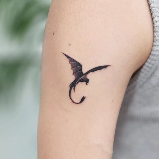 Small Minimalist Toothless on Women Arm Tattoo by @mad_tattooer