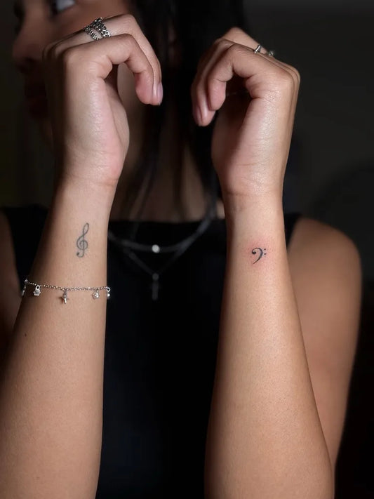 Small Minimalist Treble Clef and Music Note on Women Wrist Tattoo by @wavylevi_