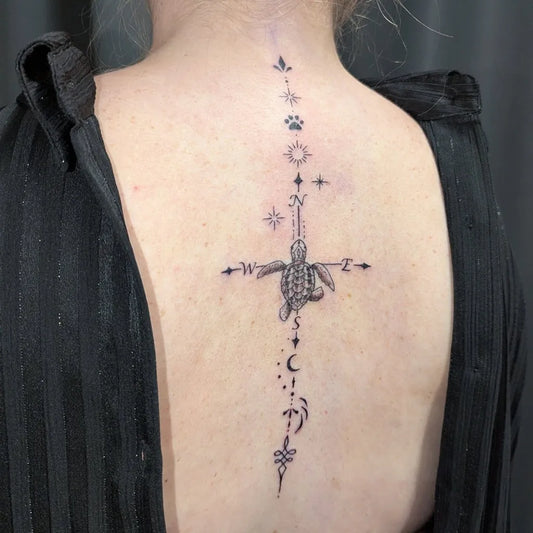 Small Minimalist Turtle Compass on Women Spine Tattoo by @ana.tetoviranje