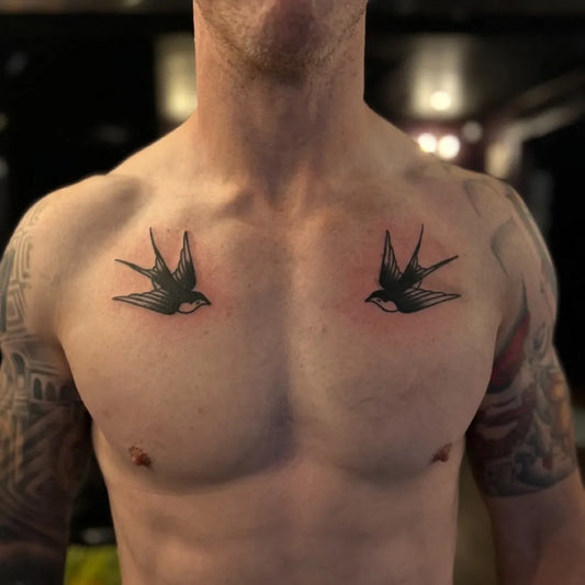 Small Minimalist Two Swallows on Men Chest Tattoo by @richardkenworthytattoos