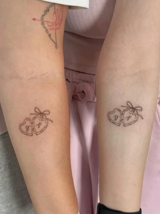 Small Minimalist Two Tied Hearts on Women Arms Tattoo by @asiia.tattoo