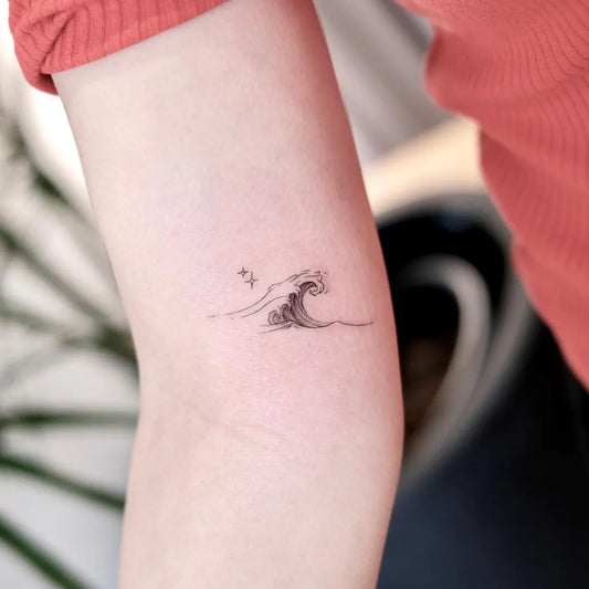 Small Minimalist Wave Tattoo on Women Arm by @cancho.mini