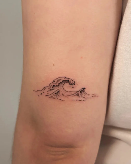 Small Minimalist Wave Tattoo on Women Arm by @enya.tattooo