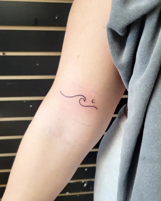Small Minimalist Wave Tattoo on Women Arm by @ginadvenuti