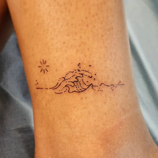 Small Minimalist Wave and Star Tattoo on Women Ankle by @deadfishtattoos