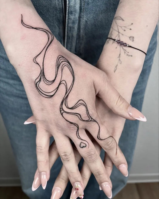 Small Minimalist Wavy Lines on Women Hands Tattoo by @brutalis.mo