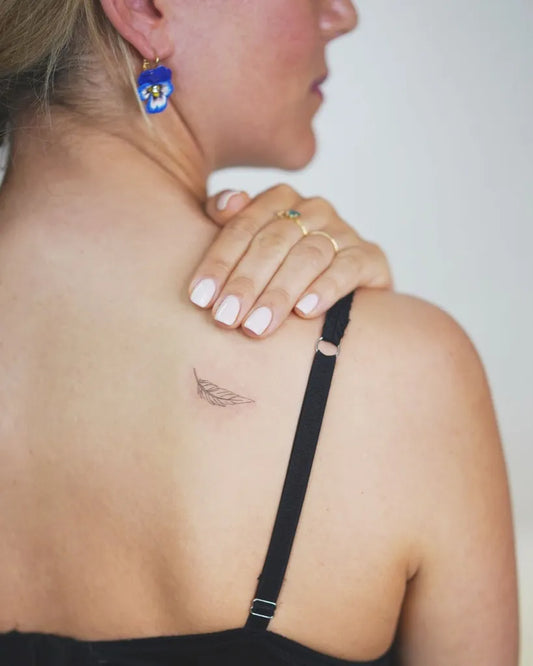 Small Minimalist Wing on Women Shoulder Tattoo by @davekulla.tattoo