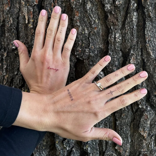 Small Minimalist Word Number Cross on Women Fingers Tattoo by @kb.artistry.studio