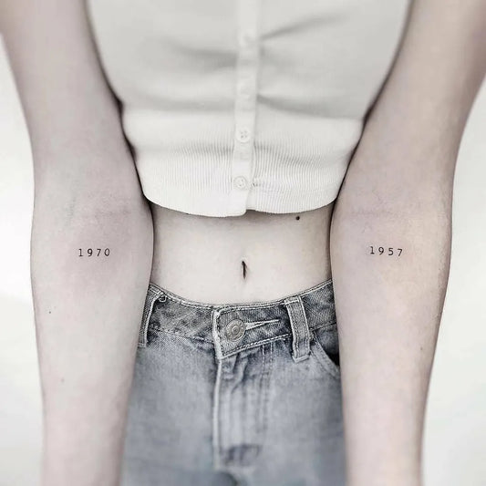 Small Minimalist Year Numbers Tattoo on Women Arms by @little.tattoos