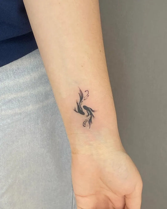 Small Minimalist Yin Yang Koi on Women Wrist Tattoo by @boss.tattoo