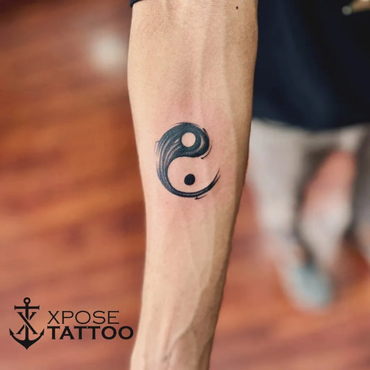Small Minimalist Yin Yang Tattoo on Men Arm by @xposetattoosjaipur