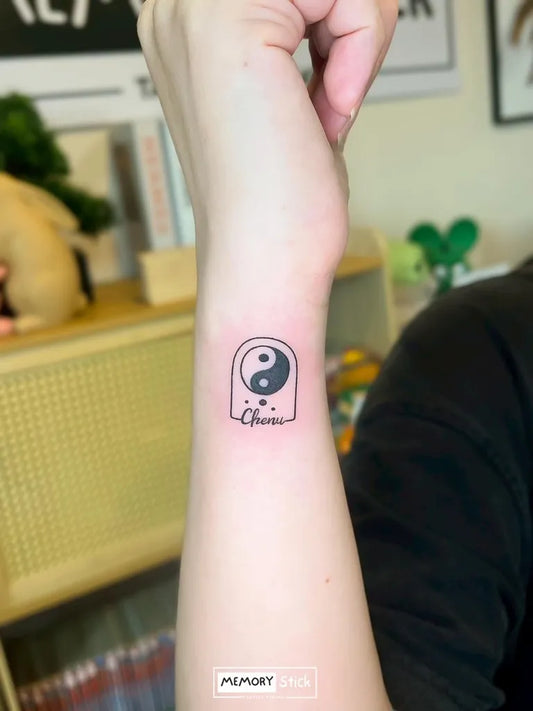 Small Minimalist Yin Yang Tattoo on Women Wrist by @memorystick.tattoo