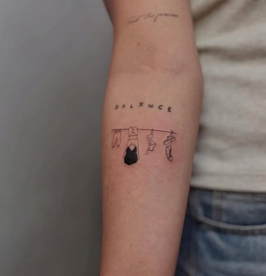 Small Minimalist clothesline balance Women Arm Tattoo by @tintahanan_tattoo