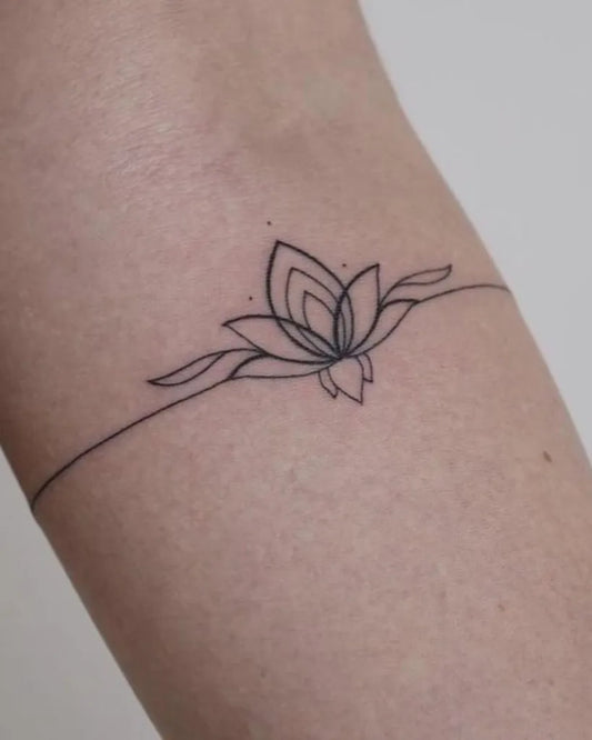 Small Minimalist lotus flower bracelet on Women forearm Tattoo by @margs_ink.girl