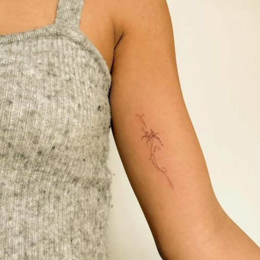 Small Minimalist palm tree branch on Women arm Tattoo by @aras.studio_