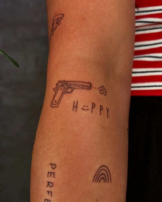Small Minimalist pizza slice gun happy text on Women Arm Tattoo by @chrisart__tattoo