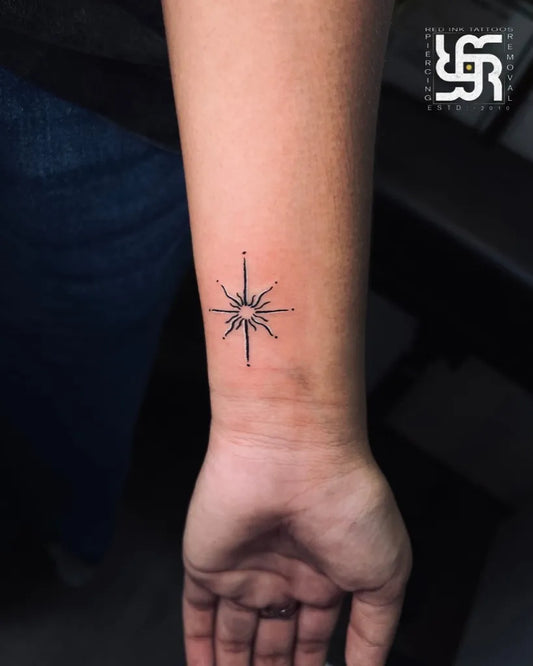 Small Minimalist starburst on Women wrist Tattoo by @redinkcitylight