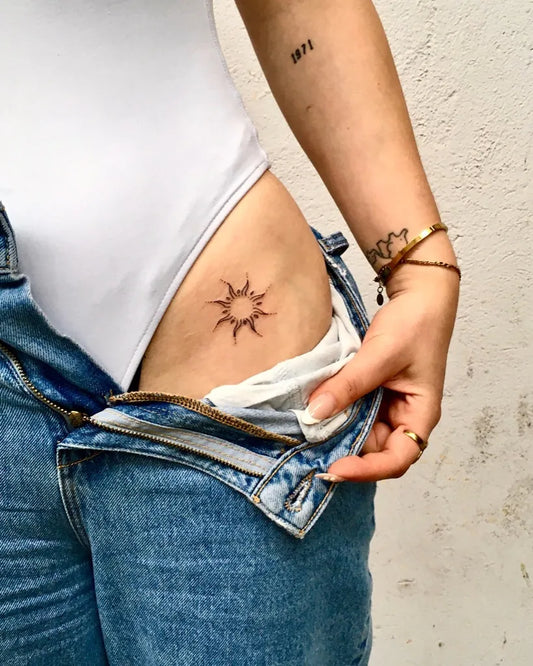 Small Minimalist sunburst on Women hip Tattoo by @patatefixe