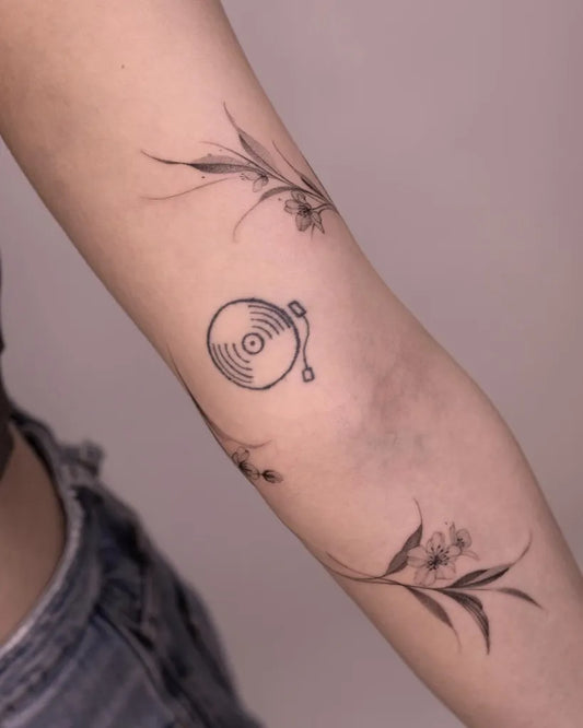 Small Minimalist turntable floral branches on Women Arm Tattoo by @tattooist_hea