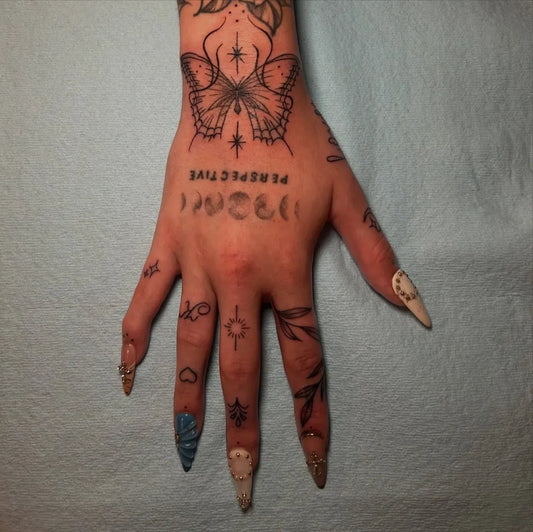Small Mystical Butterfly Moon on Women Fingers Tattoo by @sacredportaltattoo